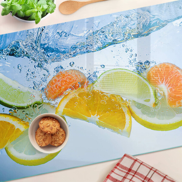 Tabla de cortar de cristal Frutas cítricas en agua
