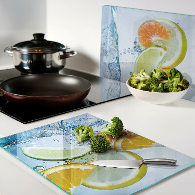 Tabla de cortar de cristal Frutas cítricas en agua