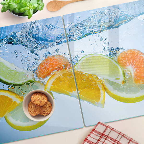 Tabla de cortar de cristal Frutas cítricas en agua