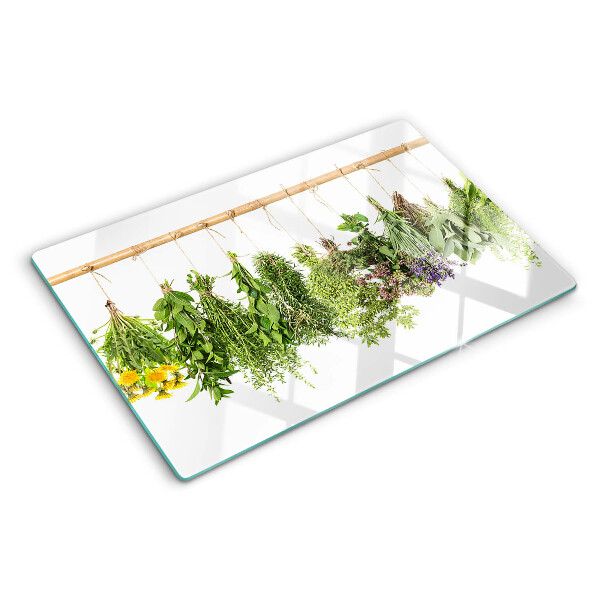 Tabla de cortar de cristal Hierbas secas en una cuerda