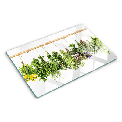 Tabla de cortar de cristal Hierbas secas en una cuerda