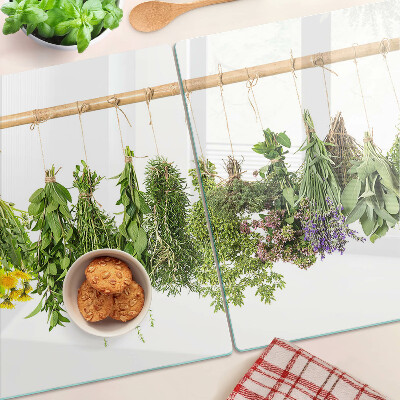 Tabla de cortar de cristal Hierbas secas en una cuerda