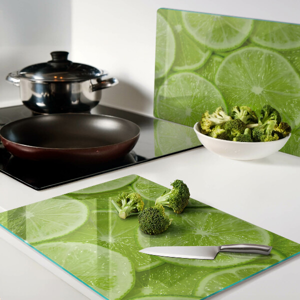 Szklana deska kuchenna Plastry limonki na zielonym tle