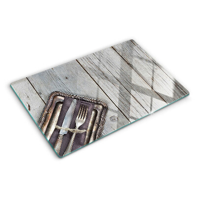 Tabla de cortar de cristal Cubiertos rústicos sobre fondo de madera.