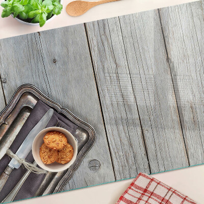 Tabla de cortar de cristal Cubiertos rústicos sobre fondo de madera.
