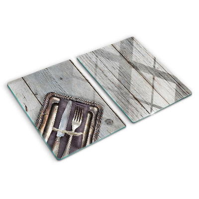 Tabla de cortar de cristal Cubiertos rústicos sobre fondo de madera.