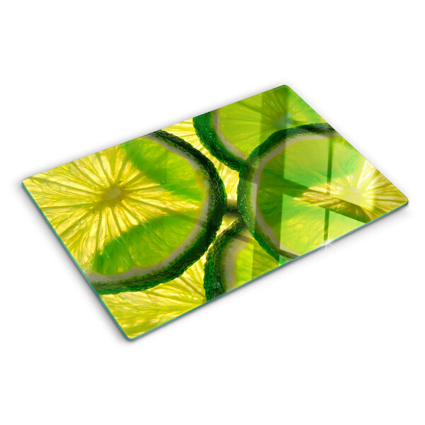 Tabla de cocina Rodajas de lima sobre un fondo verde