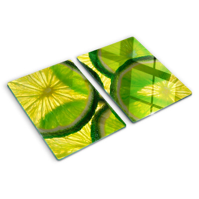 Tabla de cocina Rodajas de lima sobre un fondo verde