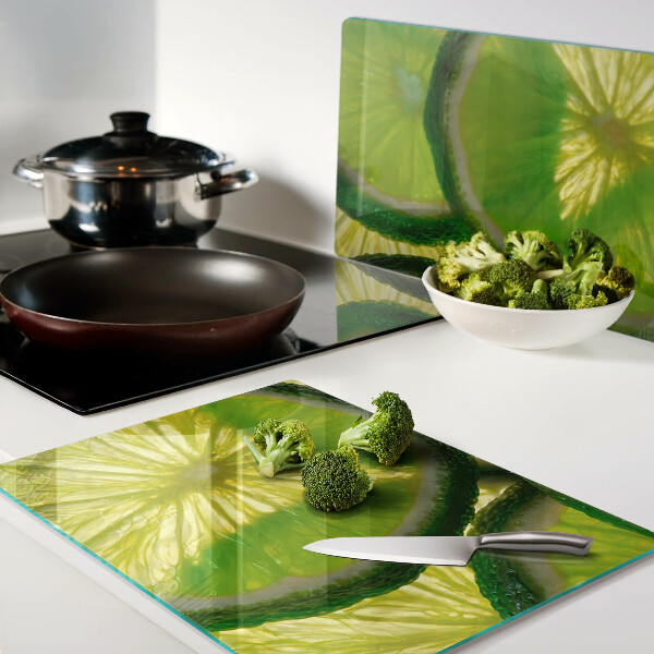 Szklana deska do krojenia Plastry limonki na zielonym tle