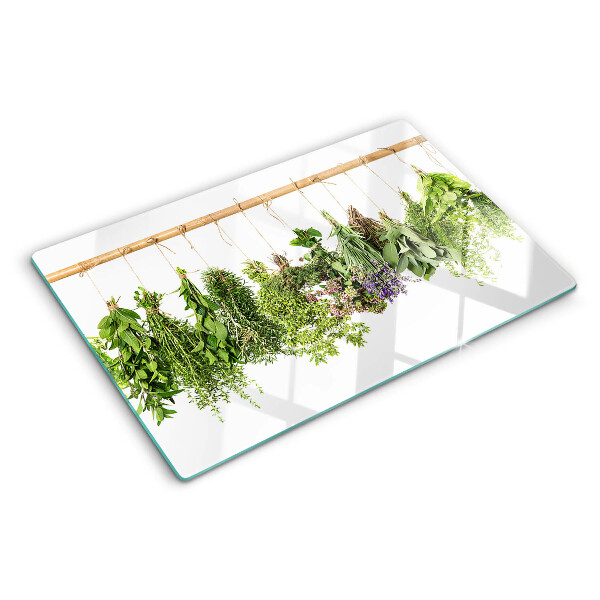 Tabla de cortar de cristal Hierbas secas en una cuerda