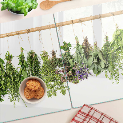 Tabla de cortar de cristal Hierbas secas en una cuerda