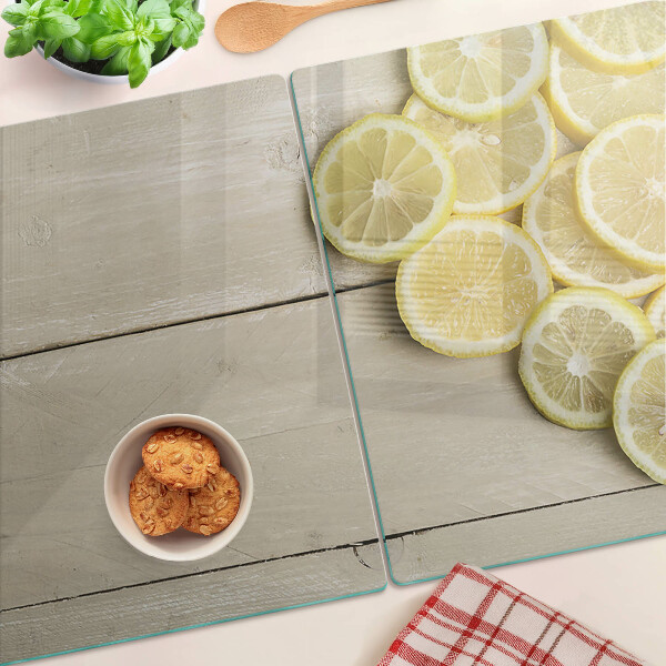 Szklana deska do krojenia Plastry cytryny na drewnianym tle