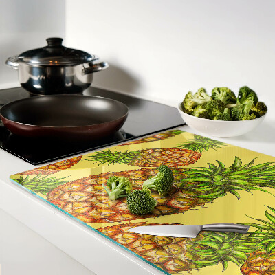 Tabla de cortar de cristal Piñas sobre un fondo amarillo