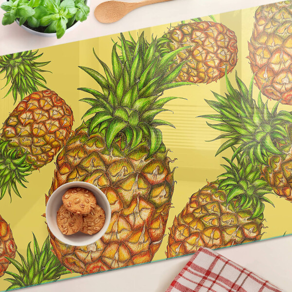 Tabla de cortar de cristal Piñas sobre un fondo amarillo