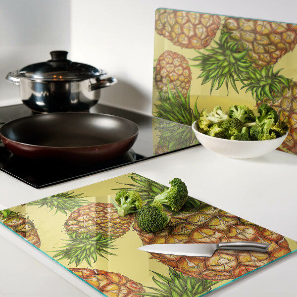 Tabla de cortar de cristal Piñas sobre un fondo amarillo