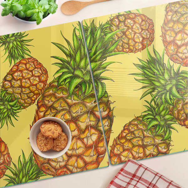 Tabla de cortar de cristal Piñas sobre un fondo amarillo