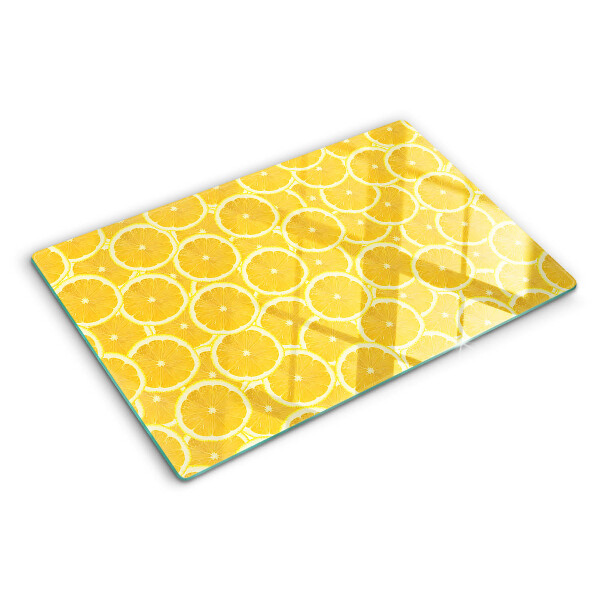 Tabla de cocina Rodajas de limón sobre un fondo amarillo