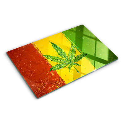 Tabla para cortar Hoja de cannabis sobre un fondo colorido