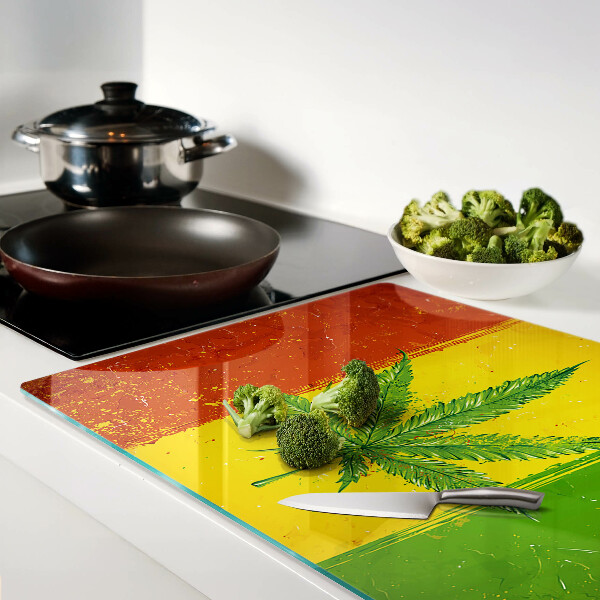 Tabla para cortar Hoja de cannabis sobre un fondo colorido
