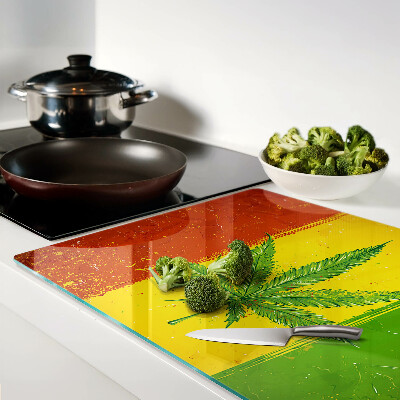 Tabla para cortar Hoja de cannabis sobre un fondo colorido