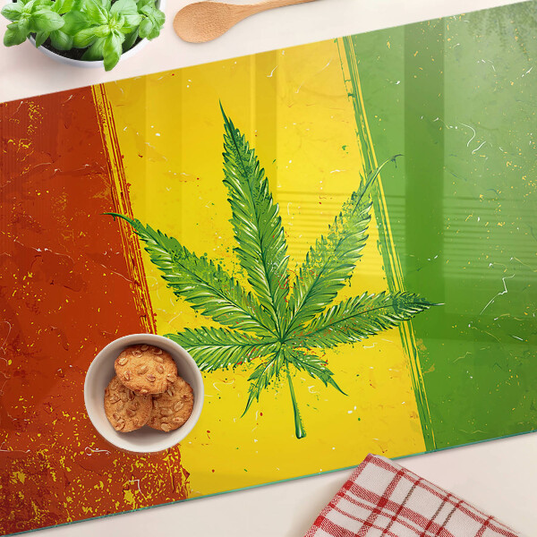 Tabla para cortar Hoja de cannabis sobre un fondo colorido