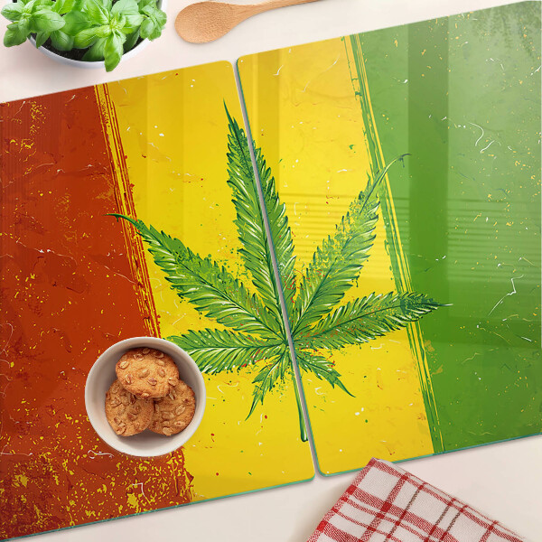 Tabla para cortar Hoja de cannabis sobre un fondo colorido