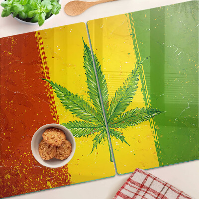 Tabla para cortar Hoja de cannabis sobre un fondo colorido