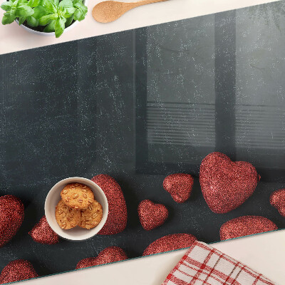 Tabla de cortar de cristal Corazones rojos sobre un fondo oscuro