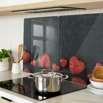 Tabla de cortar de cristal Corazones rojos sobre un fondo oscuro