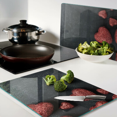 Tabla de cortar de cristal Corazones rojos sobre un fondo oscuro