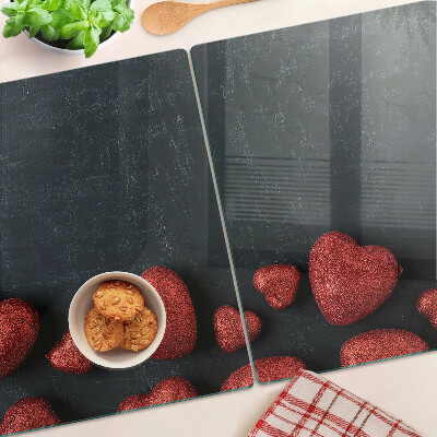 Tabla de cortar de cristal Corazones rojos sobre un fondo oscuro