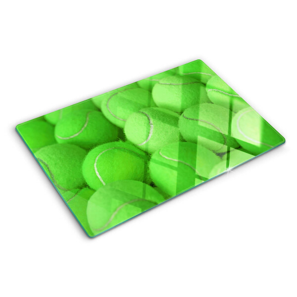 Tabla de cortar Pelotas de tenis sobre un fondo verde