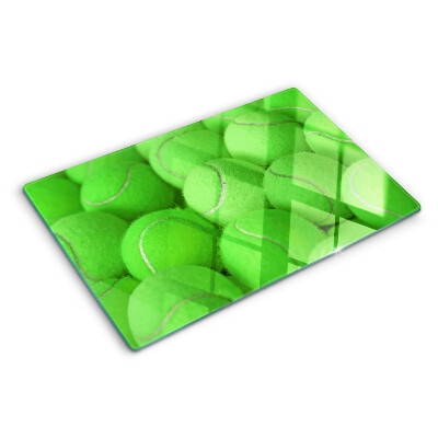 Tabla de cortar Pelotas de tenis sobre un fondo verde