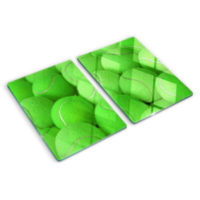 Tabla de cortar Pelotas de tenis sobre un fondo verde