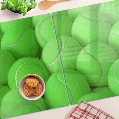Tabla de cortar Pelotas de tenis sobre un fondo verde