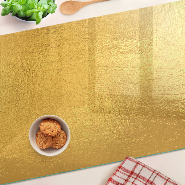 Tabla de cocina Superficie dorada con reflejos.