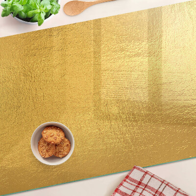 Tabla de cocina Superficie dorada con reflejos.