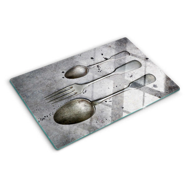 Tabla de cortar Cubiertos sobre un fondo de hormigón