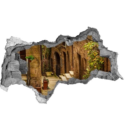 Vinilo adhesivo boquete en la pared rota Una calle encantadora en el pueblo.