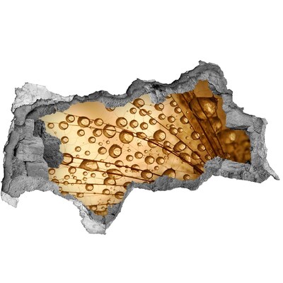 Vinilo efecto 3d pared rota irregular Una gota dorada sobre un fondo de hormigón.