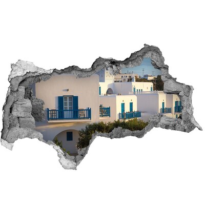 Pegatina decorativa agujero en la pared 3d Vista de casas blancas con ventanas azules.