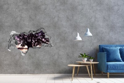 Vinilo adhesivo boquete en la pared rota Puesta de sol detrás del árbol