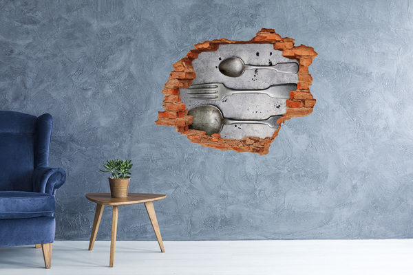 Fototapeta dziura na ścianę Złamana ściana z widokiem na sztućce