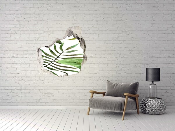Vinilo decorativo boquete pared irregular Palmera verde a través de un agujero en la pared.