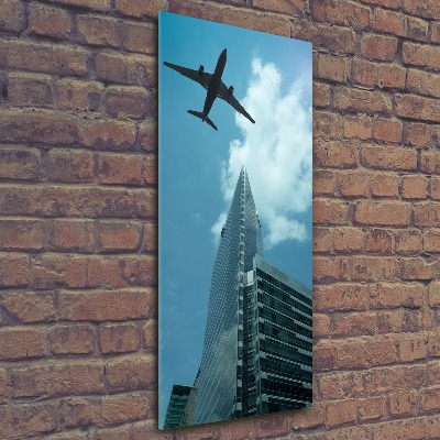 Cuadro decorativo en acrílico brillante vertical Un avión sobre la ciudad