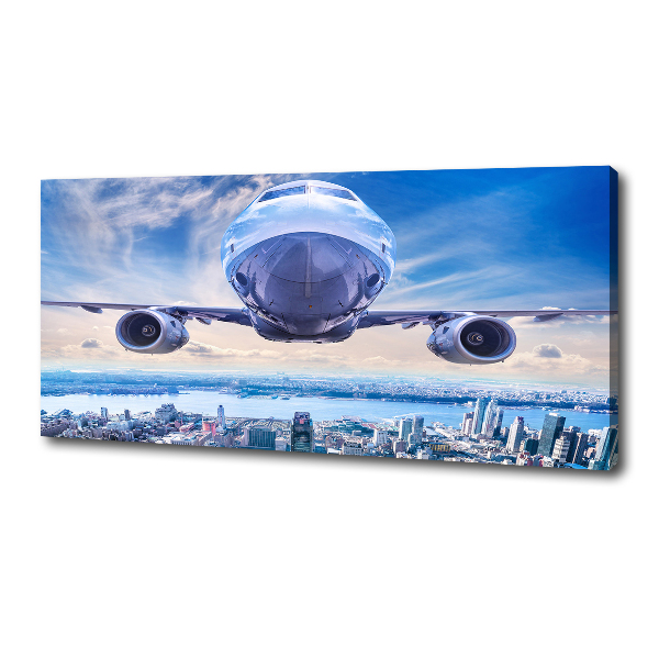 Fotocuadro en lienzo de alta calidad horizontal Un avión sobre la ciudad