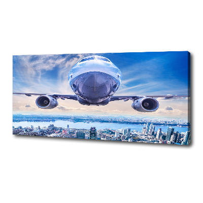 Fotocuadro en lienzo de alta calidad horizontal Un avión sobre la ciudad