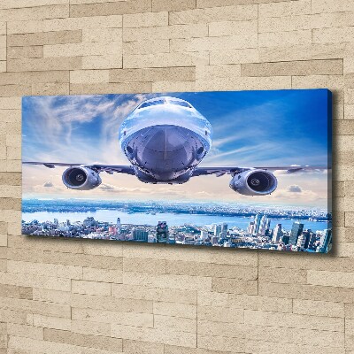 Fotocuadro en lienzo de alta calidad horizontal Un avión sobre la ciudad