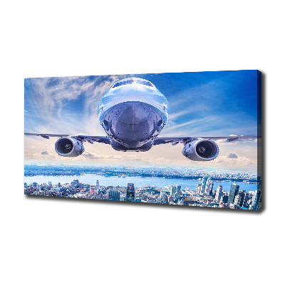 Fotocuadro en lienzo de alta calidad horizontal Un avión sobre la ciudad