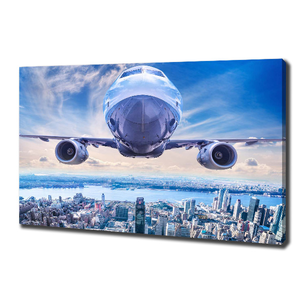 Fotocuadro en lienzo de alta calidad horizontal Un avión sobre la ciudad